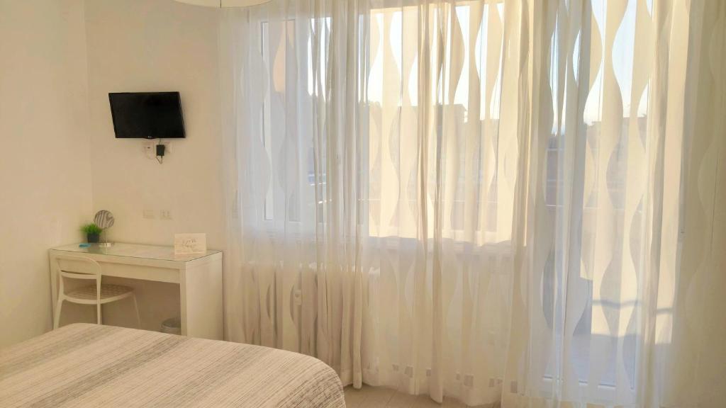 Postel nebo postele na pokoji v ubytování B&B Le Albarelle