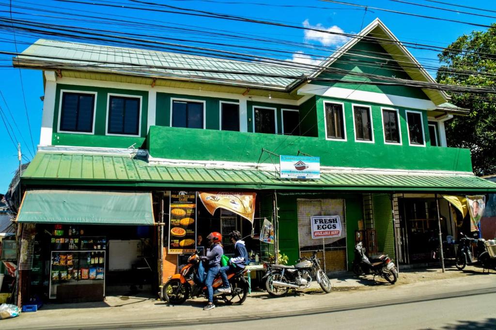 a group of people riding motorcycles in front of a building at Cabuhat Duco Lodge 1 in Naic