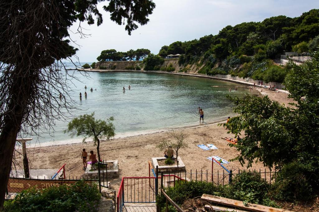 a beach with a bunch of people in the water at Bačvice beach apartment in Split