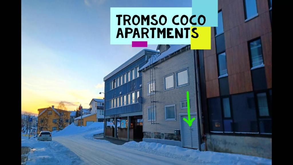 a building with a sign that reads troposcoco apartments at Tromso Coco Apartments in Center in Tromsø