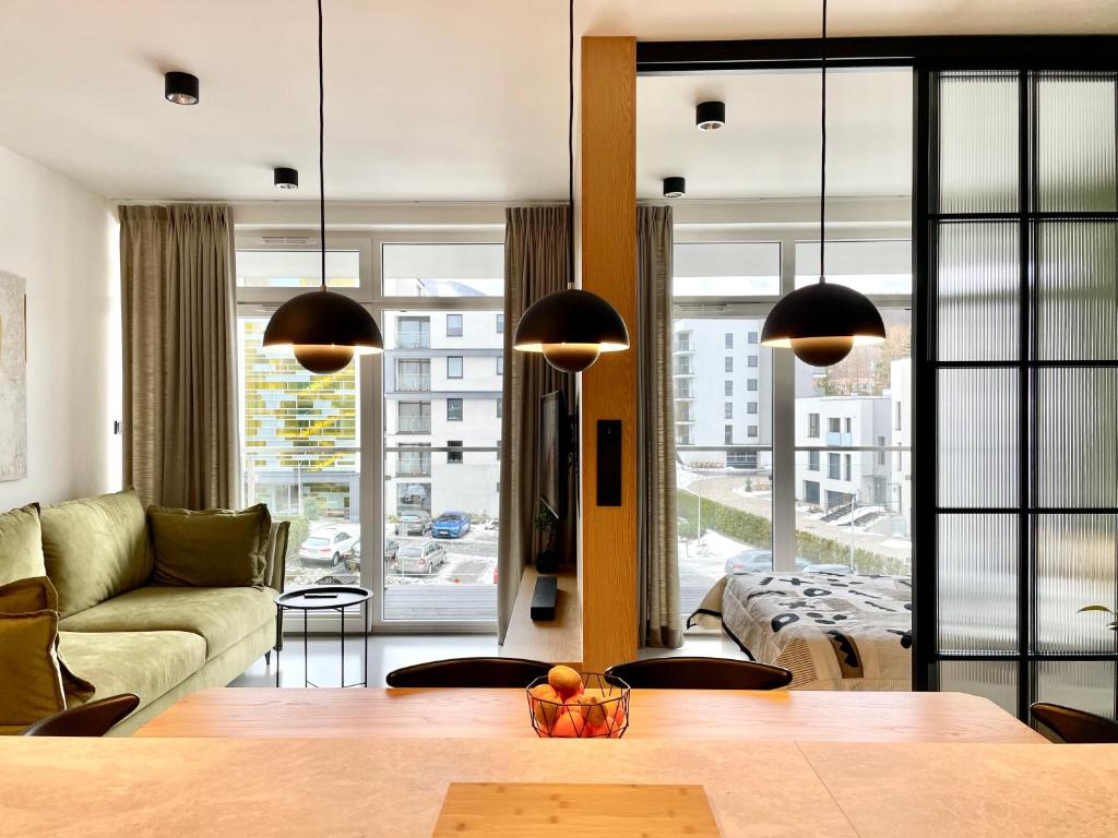 a living room with a couch and a table at Turbo Apartament pod Szyndzielnią i Dębowcem in Bielsko-Biala