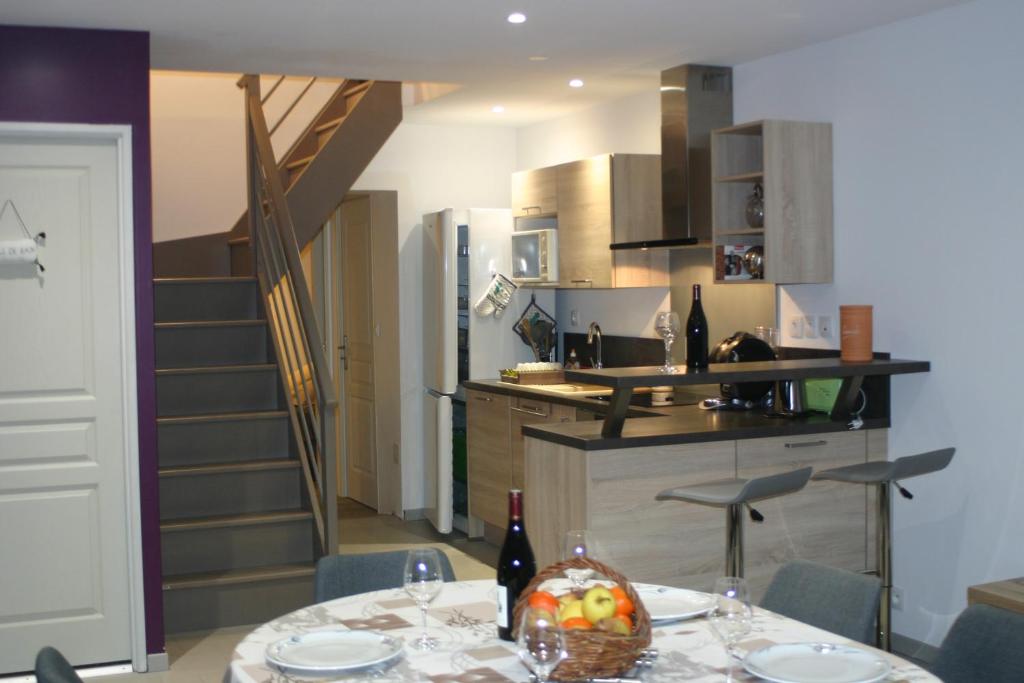 a kitchen with a table with a bowl of fruit on it at Gîte Le Balthazar in Mercurey