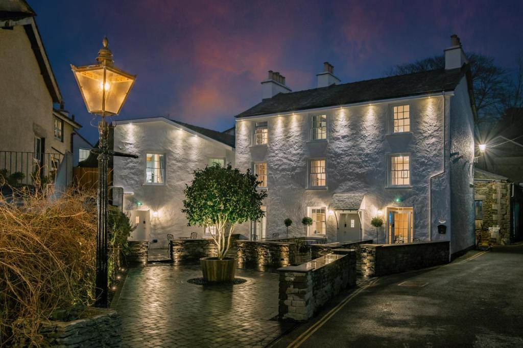 um edifício branco com uma luz de rua em frente em The White House em Bowness-on-Windermere