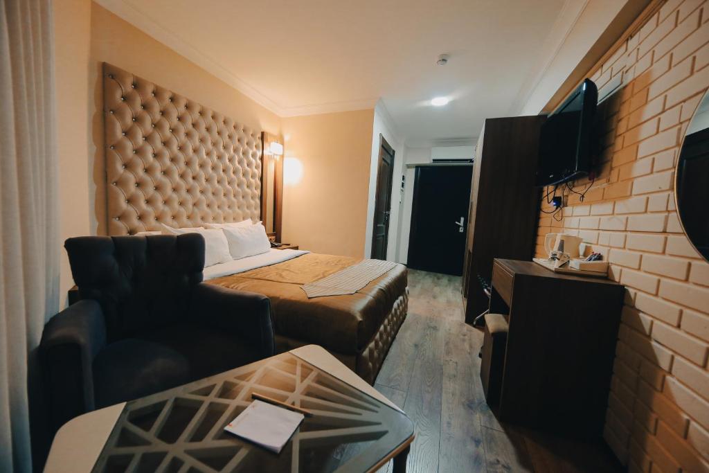 um quarto de hotel com uma cama e um sofá em Red Green Hotel em Esmirna