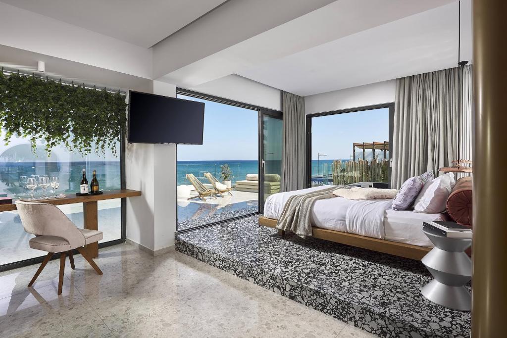 a hotel room with a balcony overlooking the ocean at Dyo Suites in Rethymno