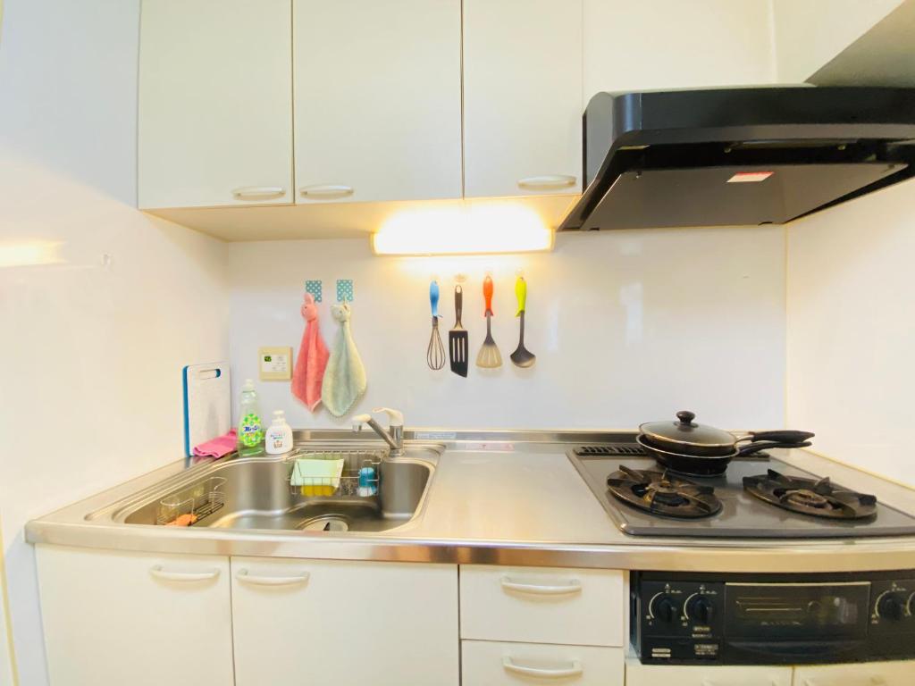a kitchen with a sink and a stove at SUNY 402 in Tokyo