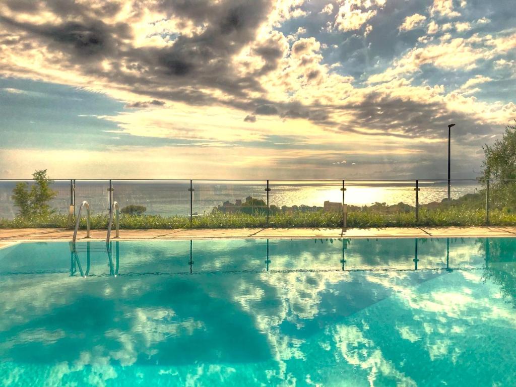 a swimming pool with a view of the ocean at Villa Santa Barbara in Cefalù