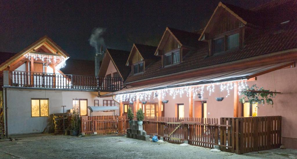 a house with christmas lights on the side of it at Ubytovanie Adina Poltár in Poltár
