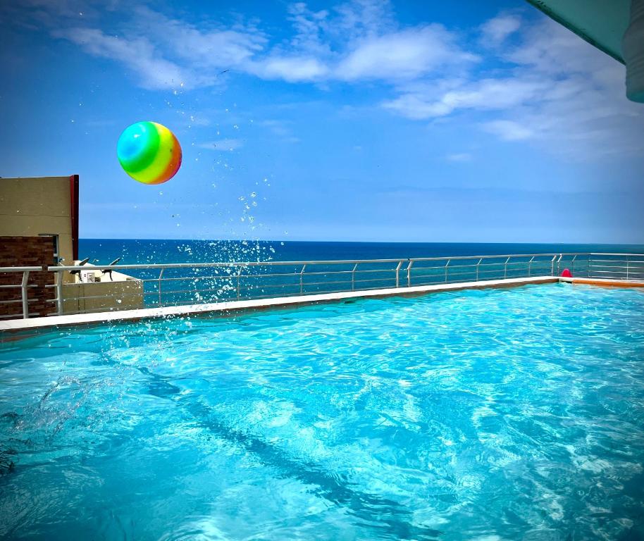 a beach ball and a beach ball in the water at Acogedor departamento junto al mar - Tonsupa in Tonsupa