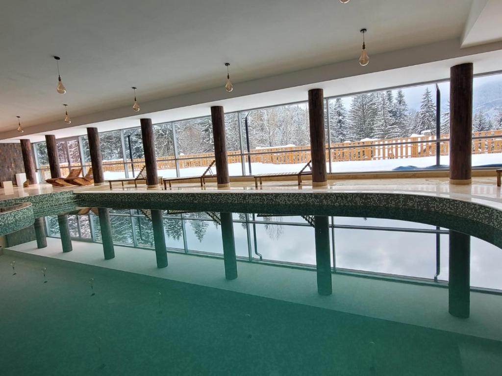 a swimming pool with a view of the snow at 7Soapte in Braşov