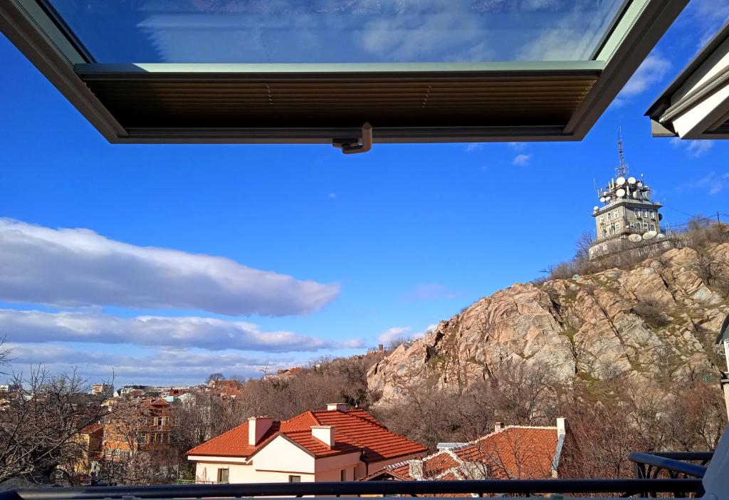 a view from the window of a building with a clock tower at Cloud 6 -Top Center,360° view,Free private parking in Plovdiv