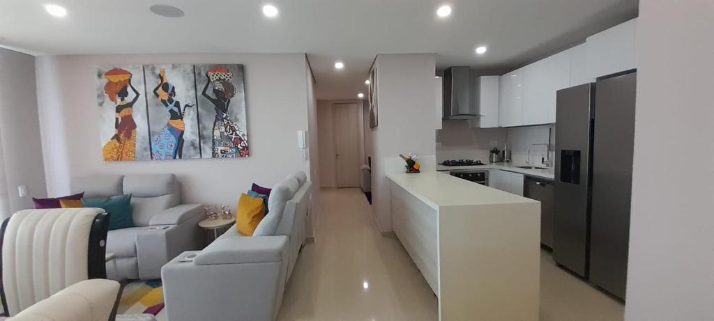 a white living room with a couch and a kitchen at The Clover Suite in Cartagena de Indias