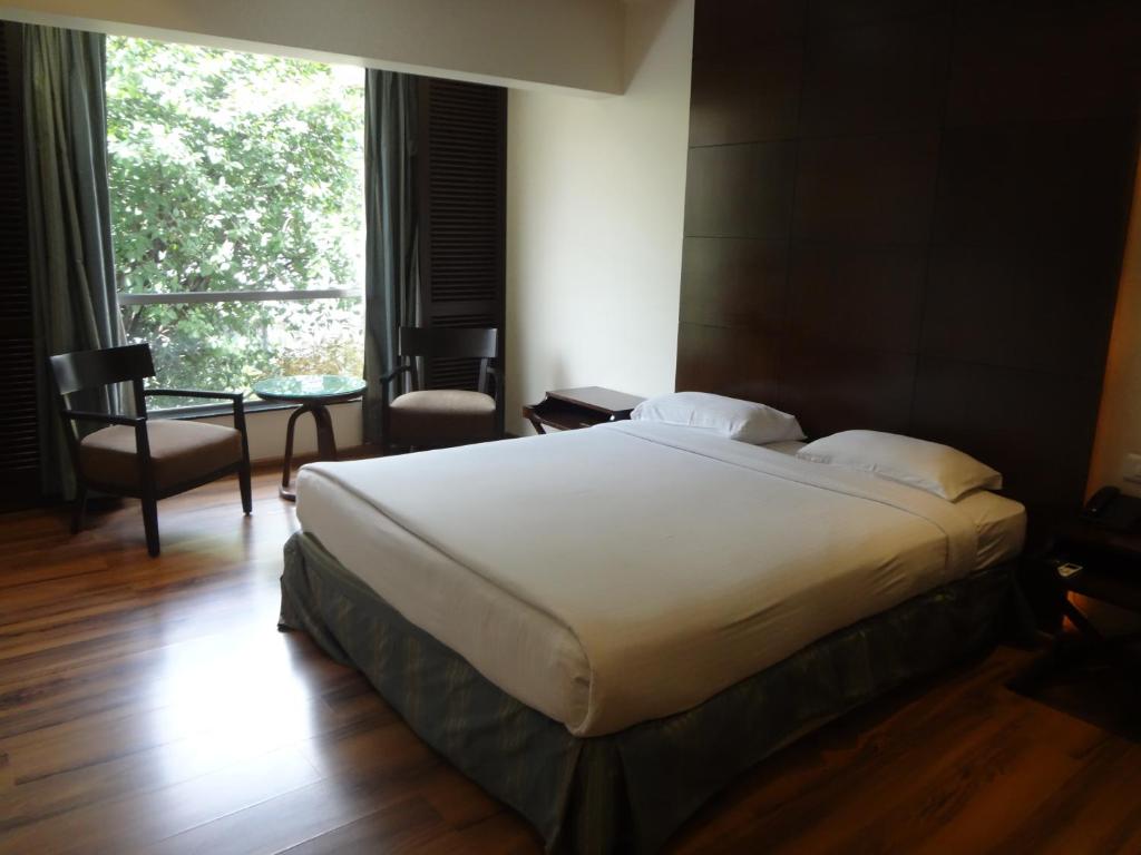 Postel nebo postele na pokoji v ubytování Shantai Hotel