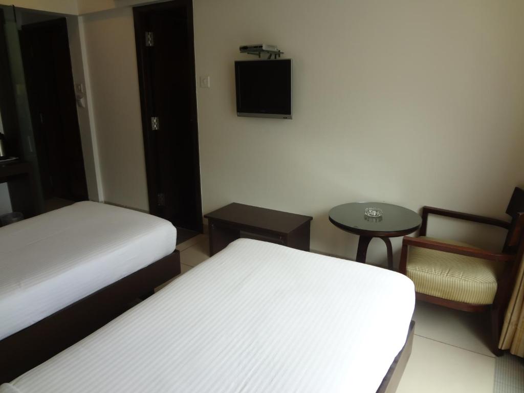 Postel nebo postele na pokoji v ubytování Shantai Hotel