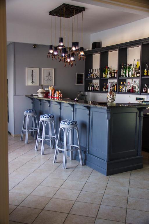 a blue bar with stools in a room at Kalidon Panorama Hotel in Kokkari