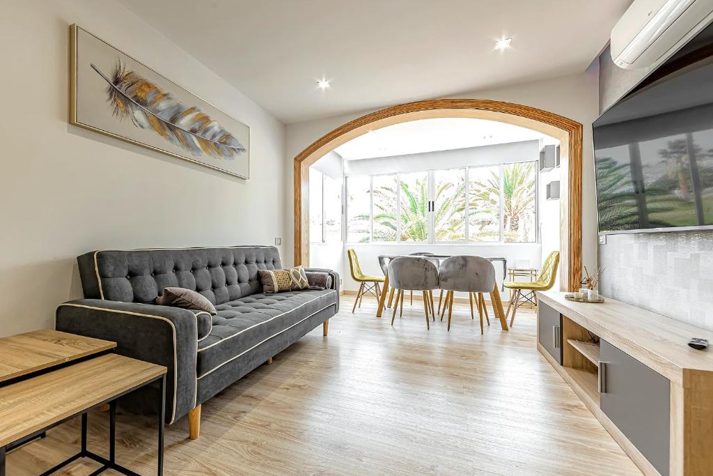 a living room with a couch and a table at Luxury 3 bedroom Perla Del Mar in Adeje