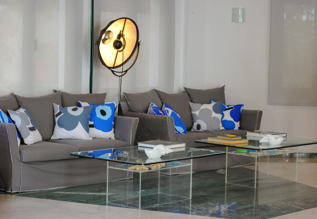 a living room with a couch and a glass table at Kalidon Panorama Hotel in Kokkari