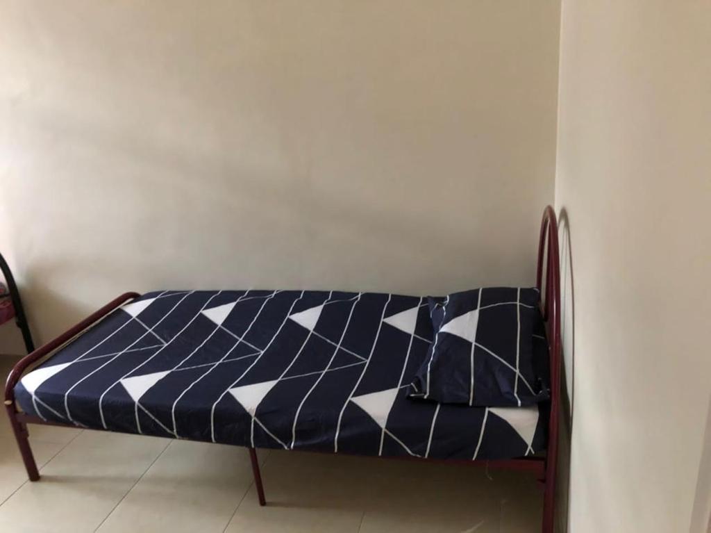 a bench with a blue and white quilt on it at Homestay Chik Da in Kampong Alor Senjaya