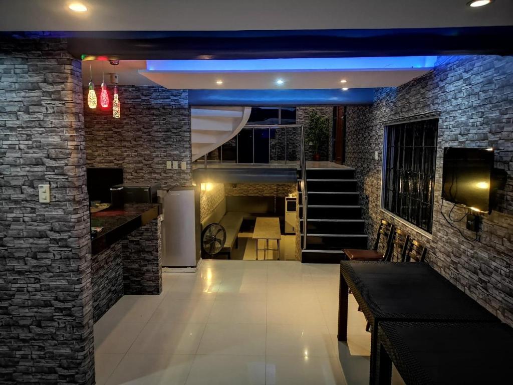 a room with a staircase and a brick wall at McHanns Place in Antipolo