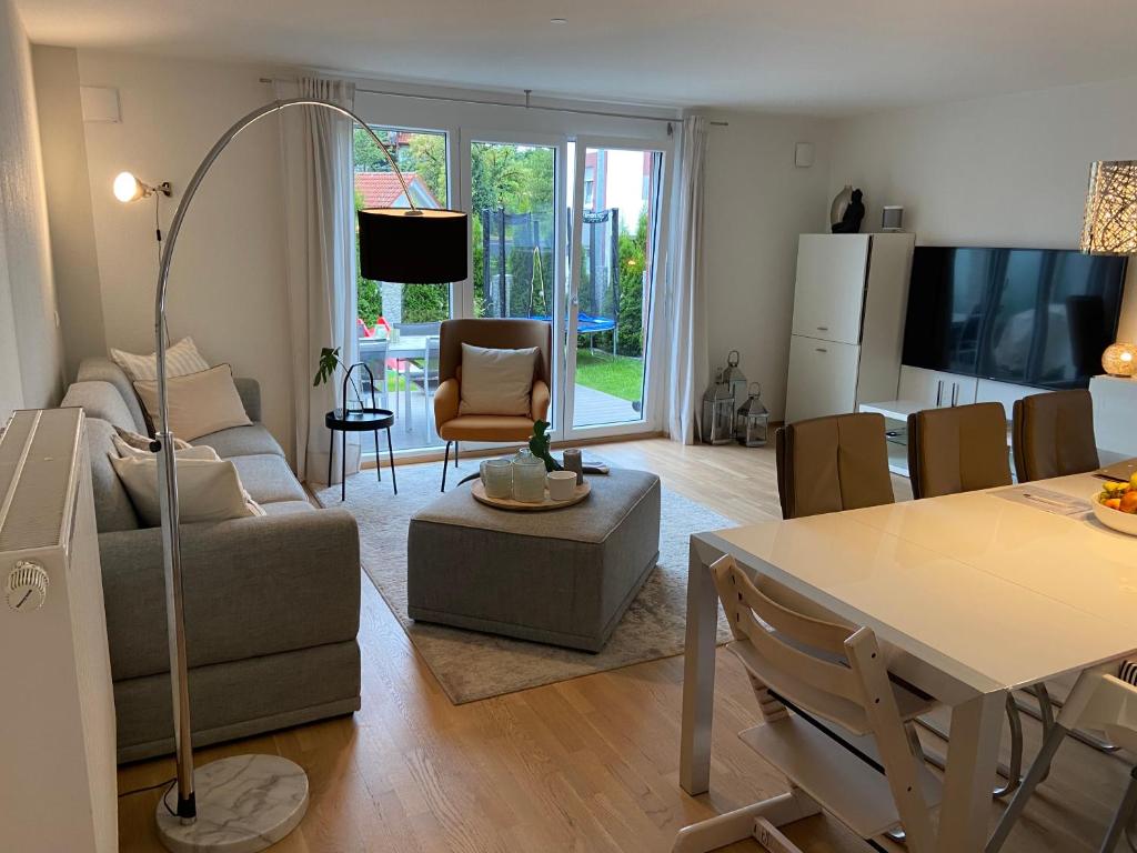 a living room with a couch and a table at Ferienwohnung I Ferienhaus am Bodensee I Meersburg I Sauna I Fitness in Meersburg