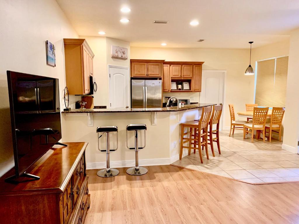 a kitchen with a bar and a dining room at Cape Canaveral near Beach House in Cape Canaveral