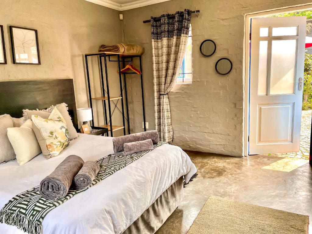 a bedroom with a large bed and a door at Studio Kay in Benoni