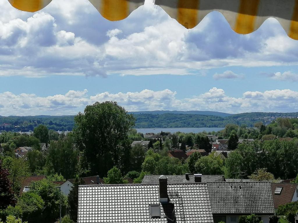 a view from a window of a town with trees at Sonnige Ferienwohnung mit Seeblick in Uhldingen-Mühlhofen