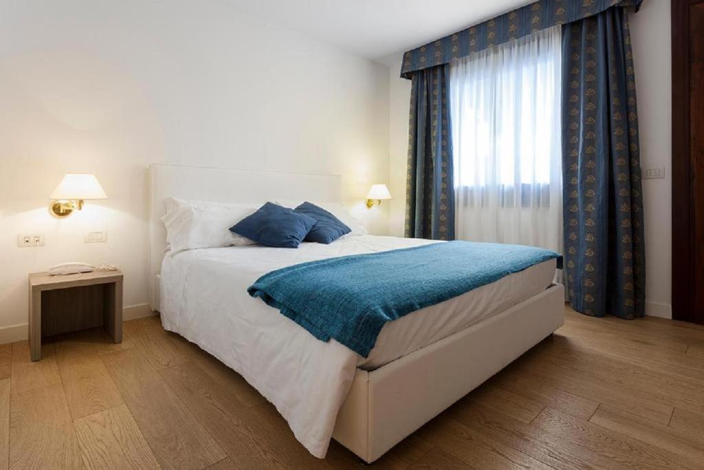 Posteľ alebo postele v izbe v ubytovaní Hotel Luna