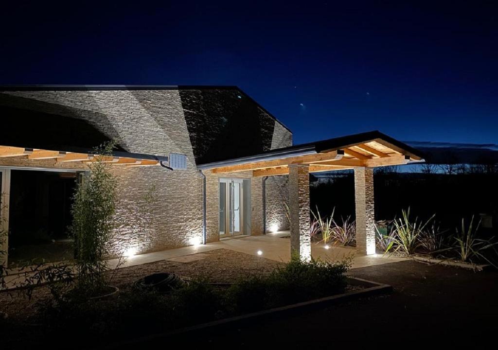 una casa de ladrillo con luces delante de ella por la noche en Hotel Luna, en Vigonovo