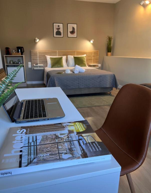 a room with a desk with a laptop on top of it at Luxor Suites Venizelou in Thessaloniki
