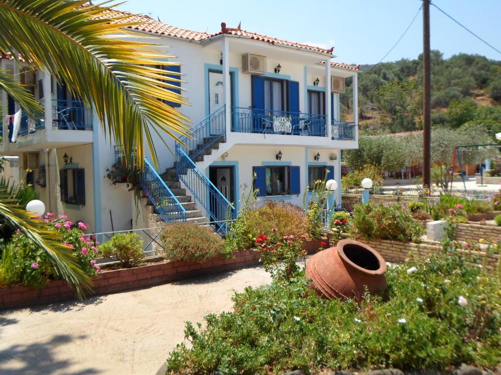 Casa blanca con flores y balcones azules en Villa Chrisanthi en Gera