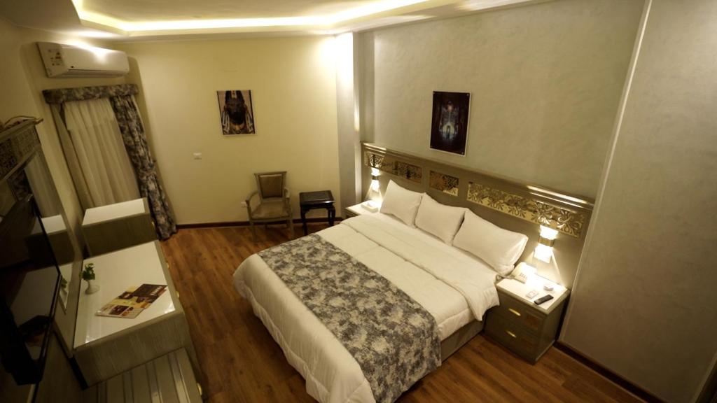 A bed or beds in a room at Lotus Luxor Hotel