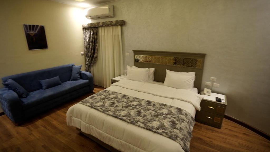 A bed or beds in a room at Lotus Luxor Hotel