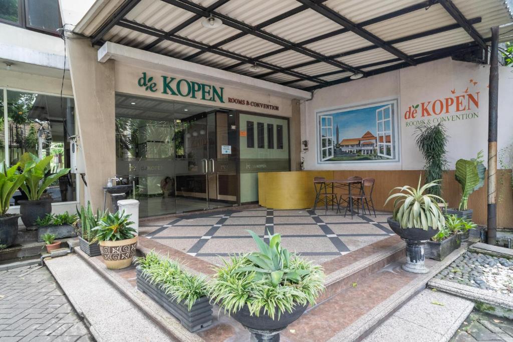 a store front with potted plants in front of it at Urbanview Hotel de Kopen Malang by RedDoorz in Malang