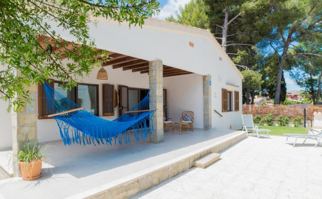a house with a hammock on the front of it at Villa Can Ordinas in Alcudia