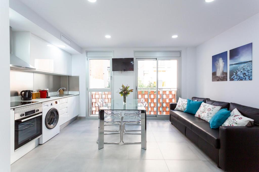 a living room with a couch and a table at 8 lacus in Hospitalet de Llobregat