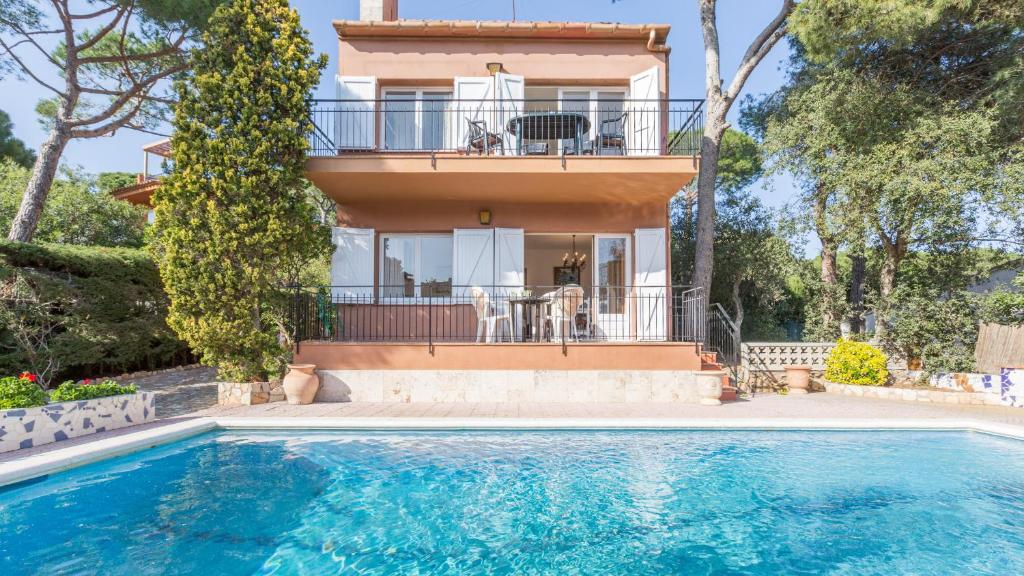 a house with a swimming pool in front of a house at 1Benet 1 - Calella de Palafrugell in Calella de Palafrugell
