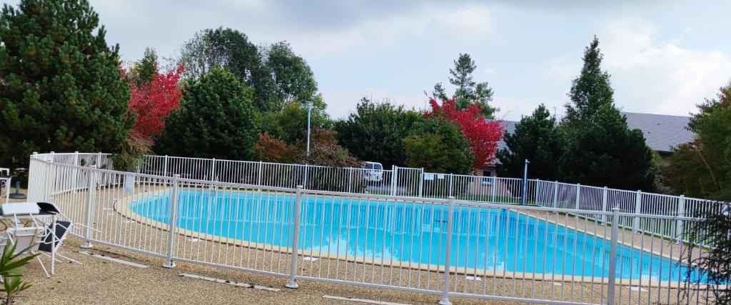 uma piscina com uma cerca à volta em Appartement avec piscine près de Honfleur em Équemauville