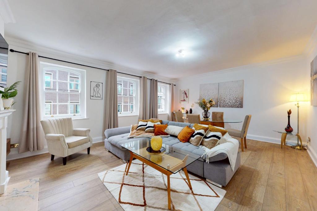 a living room with a couch and a table at Park Lane Apartments - Clarges Street in London