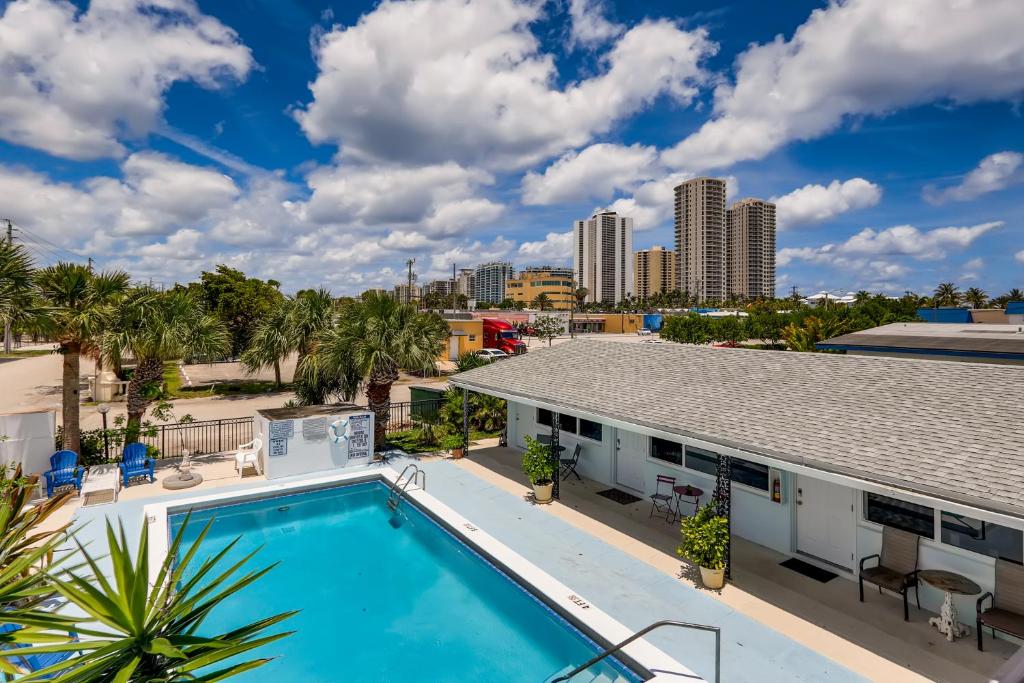 a swimming pool with a view of the city at !!Coral Sands 1 Bedroom Stunner!! in West Palm Beach