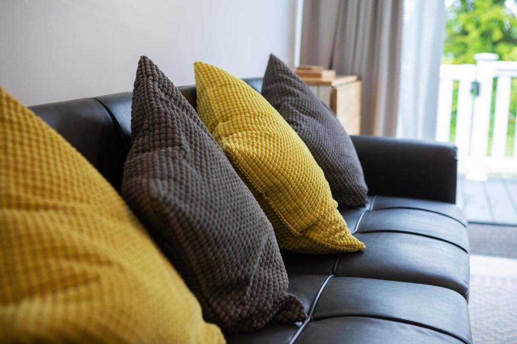 a bunch of pillows sitting on a couch at Belle Aire Holiday Park in Hemsby