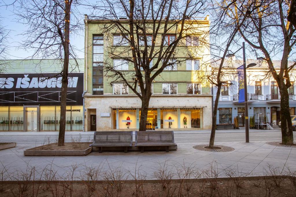 a building with two benches in front of it at Art & Comfort Home in Kaunas
