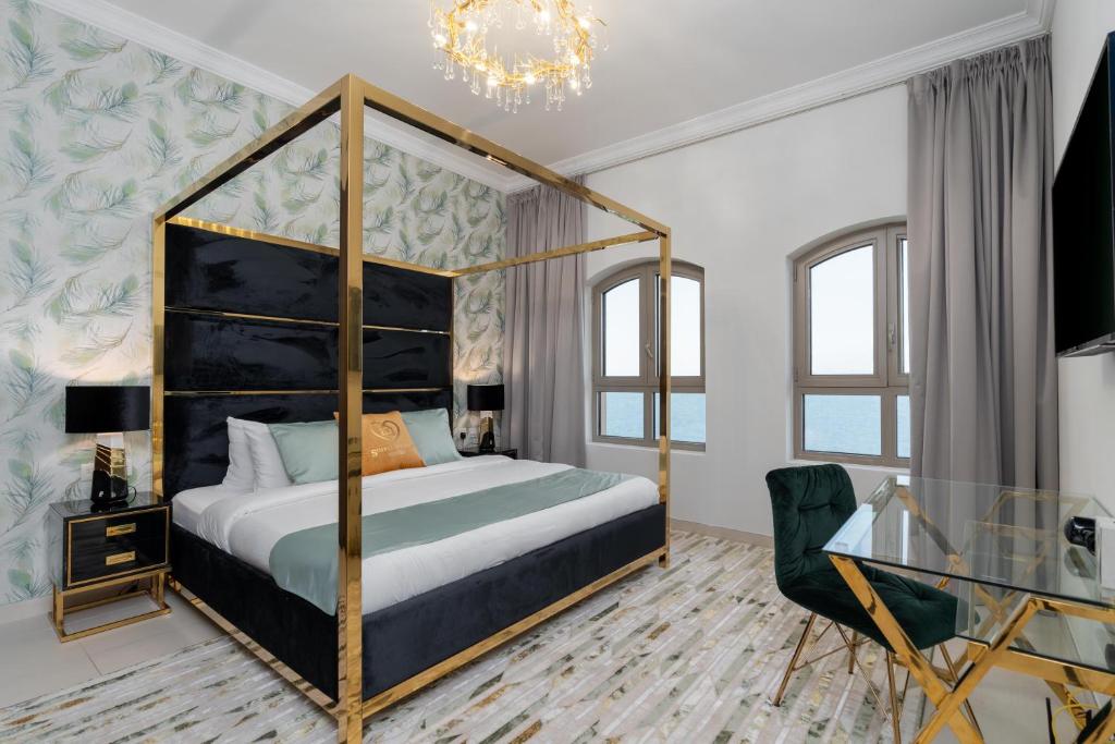 a bedroom with a four poster bed and a chair at Luxury Private Pool Penthouse by GLOBALSTAY Holiday Homes in Dubai