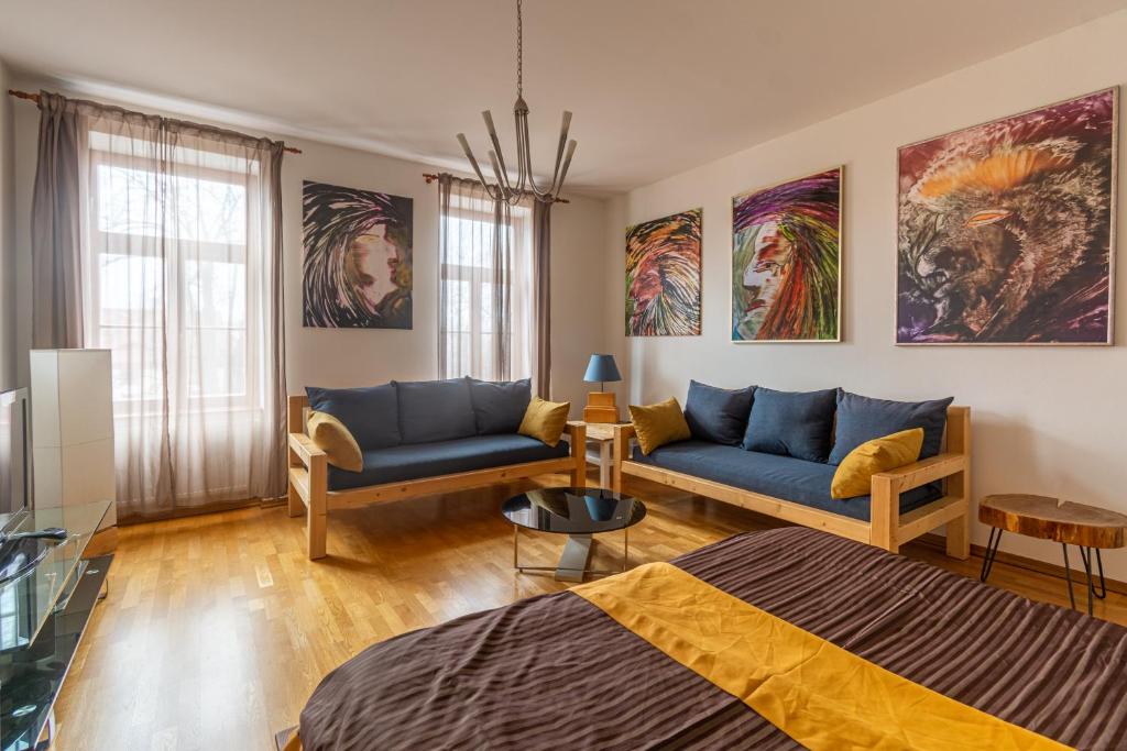 a living room with a bed and a couch at Apartment Sirius C in center of CB. in České Budějovice