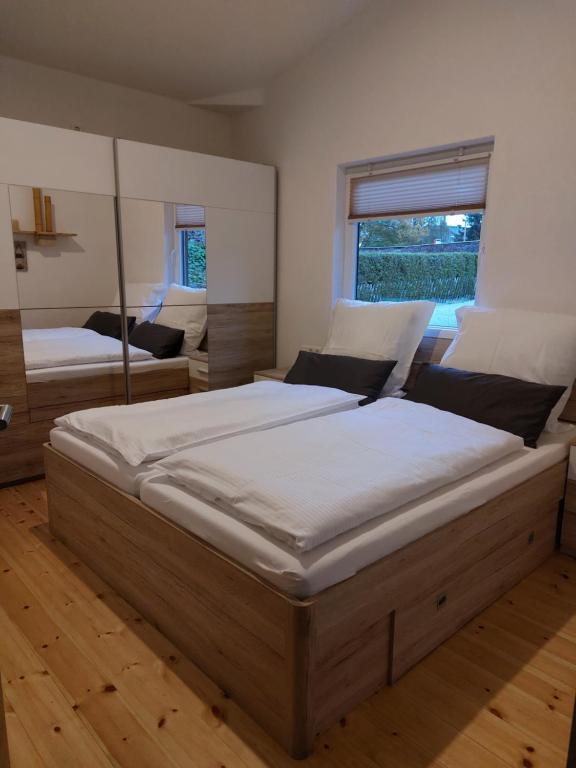 a large bedroom with two beds and a window at elephants Ferienhaus Haus West in Jahnsdorf