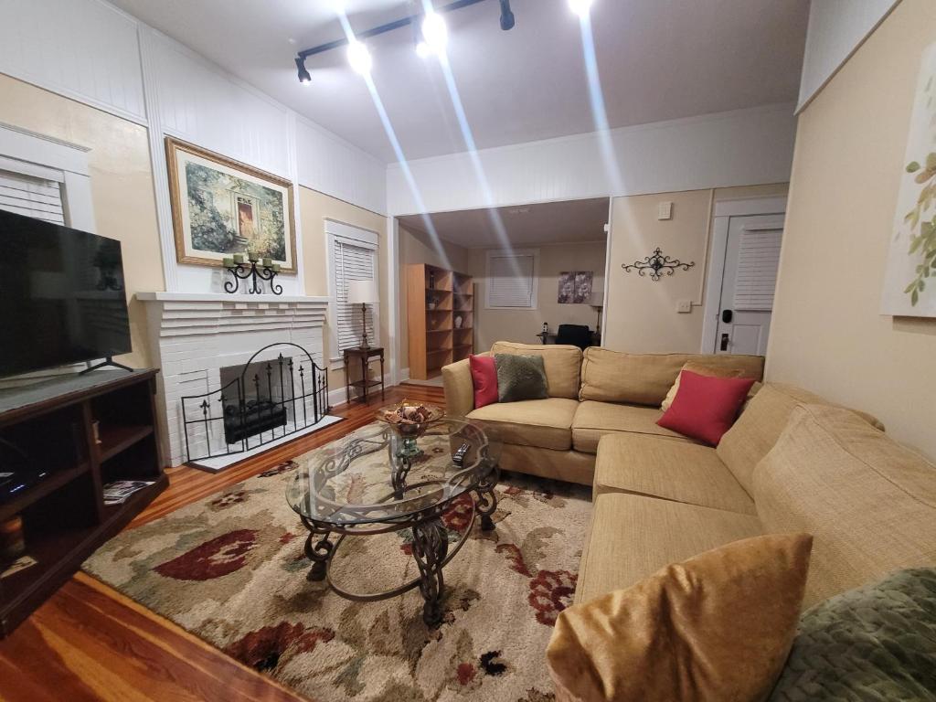 a living room with a couch and a table and a tv at EXQUISITE FAMILY HOME in Lakeland