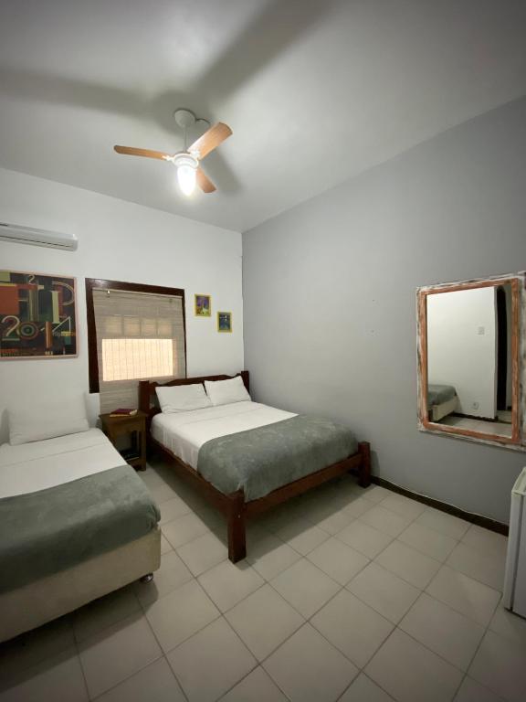 Postel nebo postele na pokoji v ubytování MAI Chameguin Hospedagens Paraty