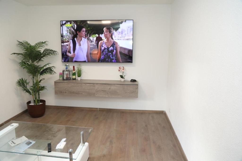 a living room with a flat screen tv on a wall at Ferienwohnung Kassel in Kassel
