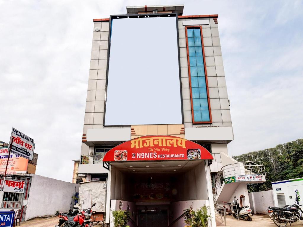 a building with a large sign on top of it at OYO 85559 The Nine's in Patna