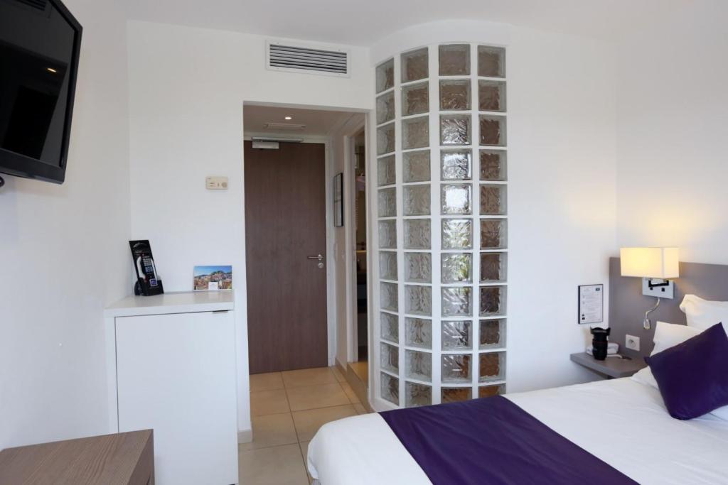 Postel nebo postele na pokoji v ubytování Hôtel de la Plage - HDLP